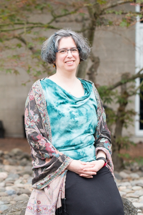 Fran Poodry seated and wearing a teal blouse